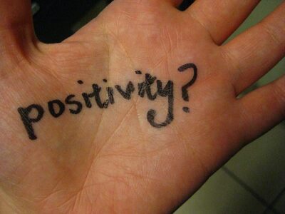 Positivity written on a persons hand