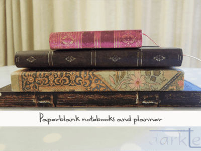 a pile of paperblank notebooks
