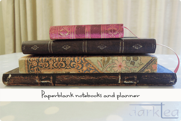 a pile of paperblank notebooks