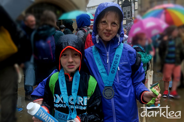 Wet children after doing the Oxford Half Marathon School's challenge in the rain
