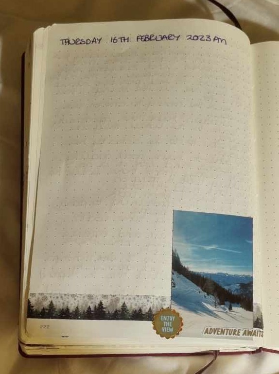 page in a dot grid notebook with the date at the top and at the bottom a photograph, washi tape and some stickers as decoration