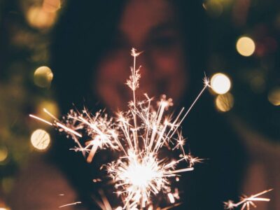 woman holding a sparkler in front of her