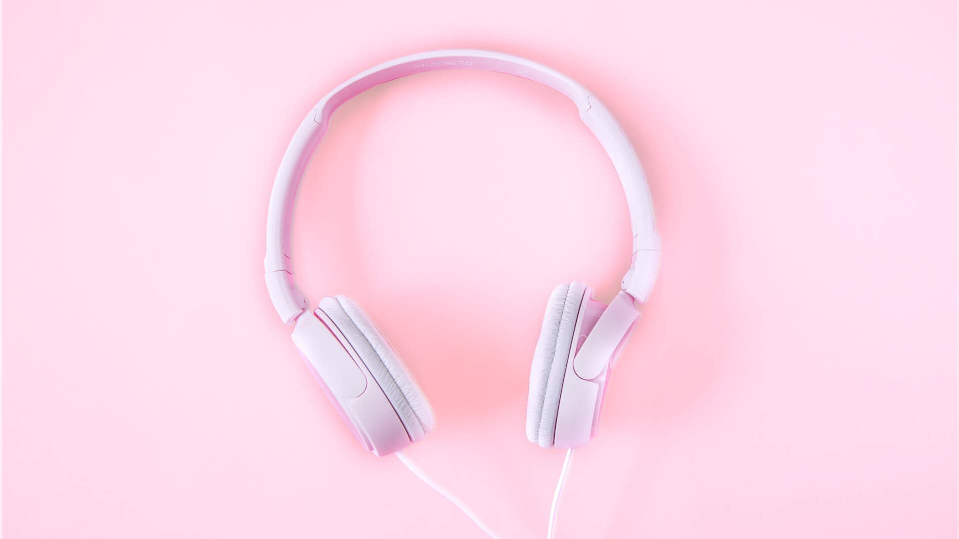 pink headphones against a pink background